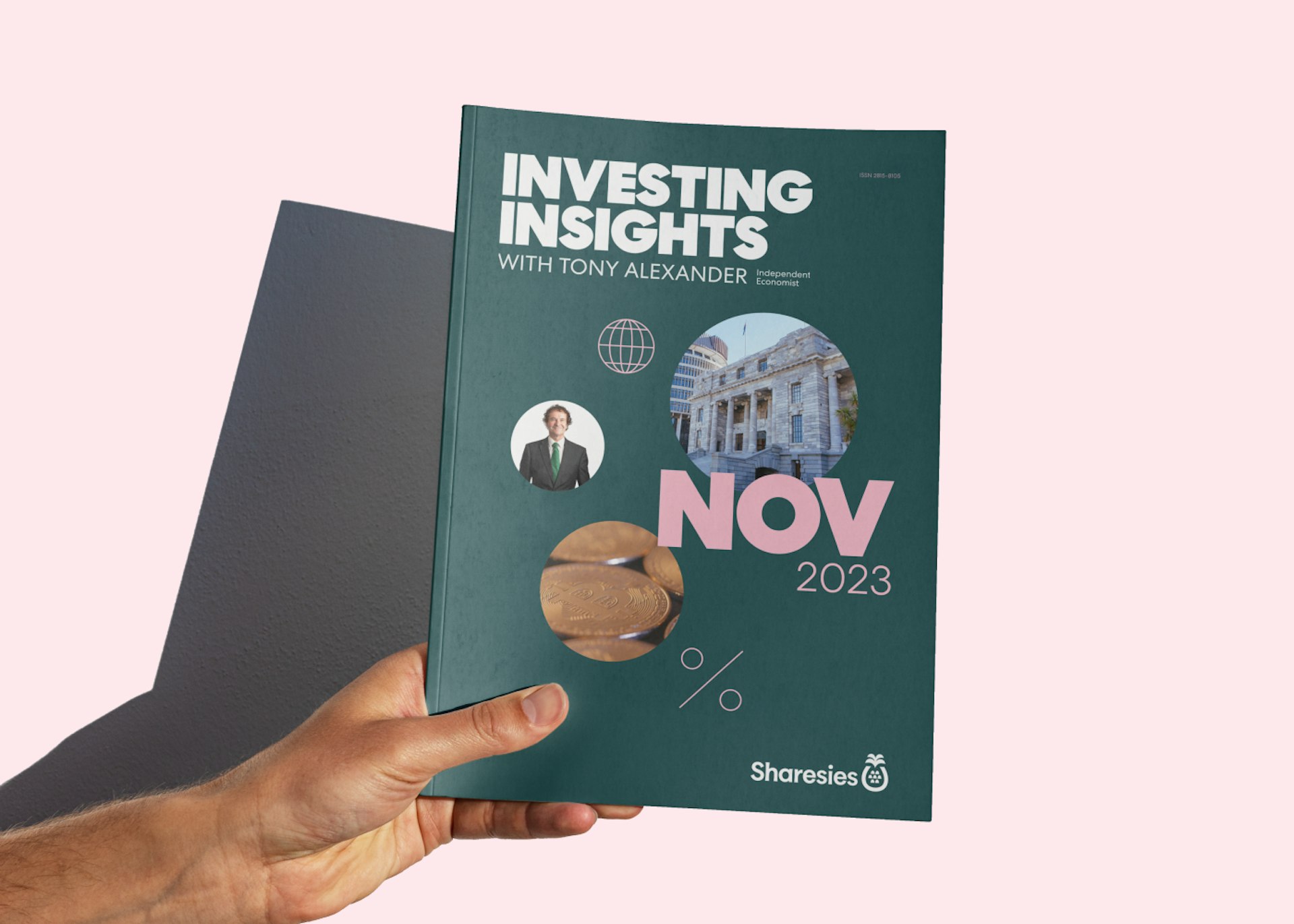 A hand holds Tony's November 2023 report on a pink background