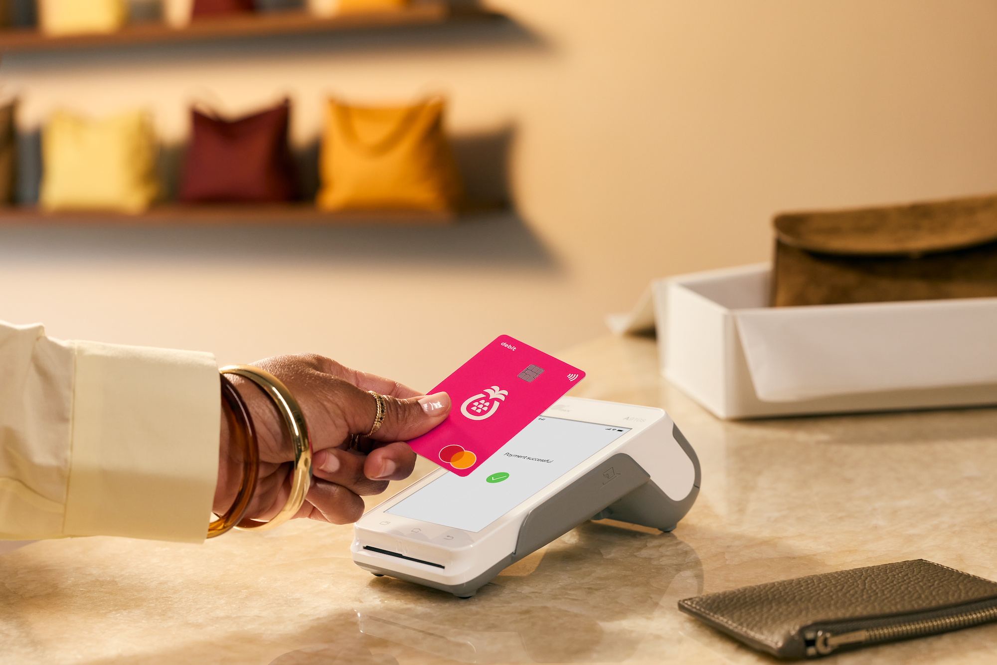 Woman paying with a Sharesies card in a handbag store 