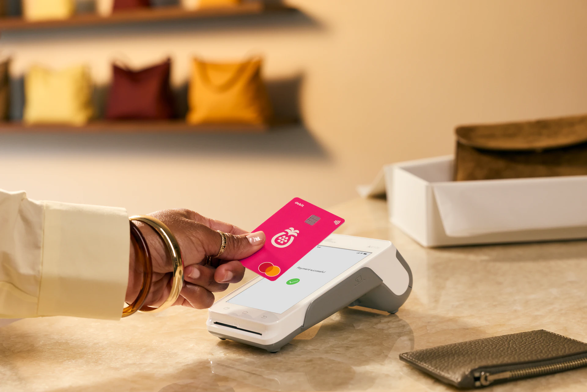 Woman paying with a Sharesies card in a handbag store