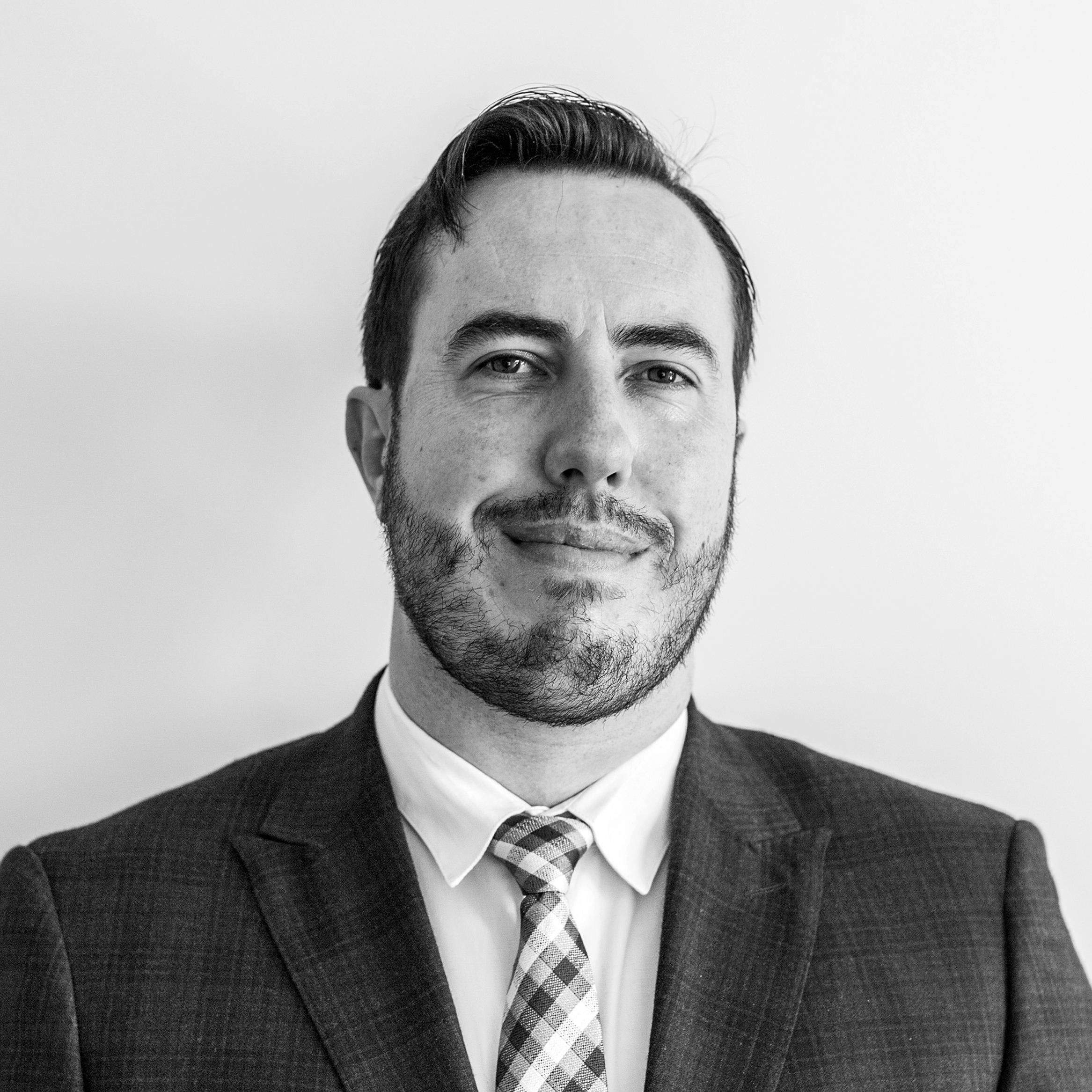 Black and white photo of Hayden Munro. Man wearing a suit. 